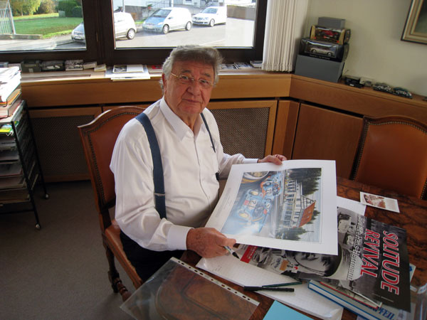 Hans Herrmann, signing a limited edition print of the painting
